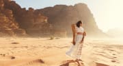 a woman in white dress in wadi rum