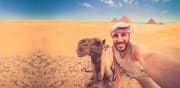 A happy traveller in front of Giza Pyramids