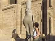 a woman in front of edfu temple, Hurghada & Nile Cruise Tour — 14 Days of Red Sea Beaches & Upper Egypt Temples