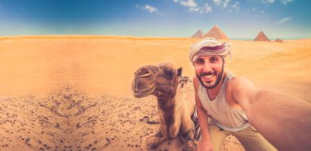 A happy traveller in front of Giza Pyramids