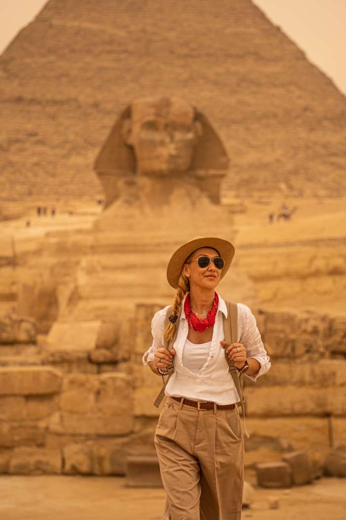 Woman standing in front of the background of Giza pyramids and Sphinx, Alexandria Shore Excursions