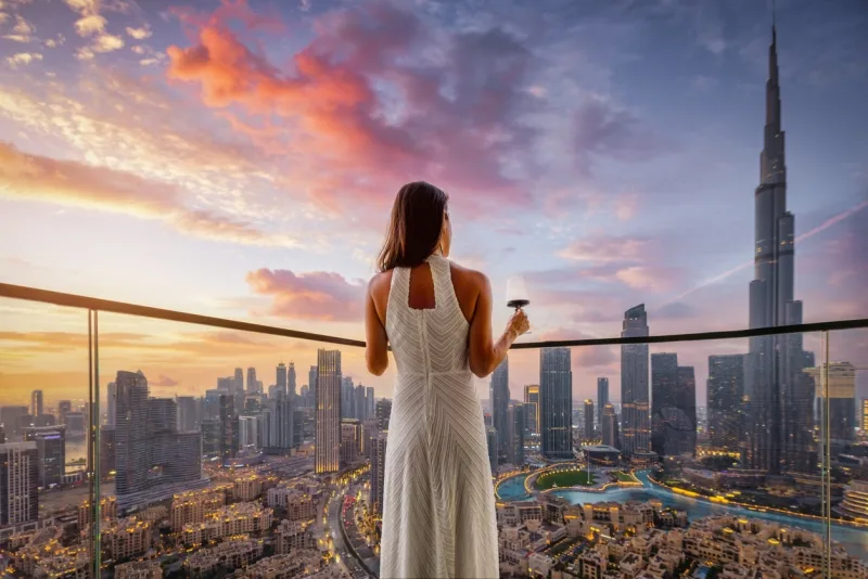 A woman enjoys the sunset view in one of the best hotels in Dubai