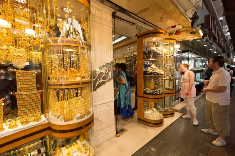 People at the Dubai Gold Souk in Dubai, United Arab Emirates. It lined with hundreds of jewellery stores.
