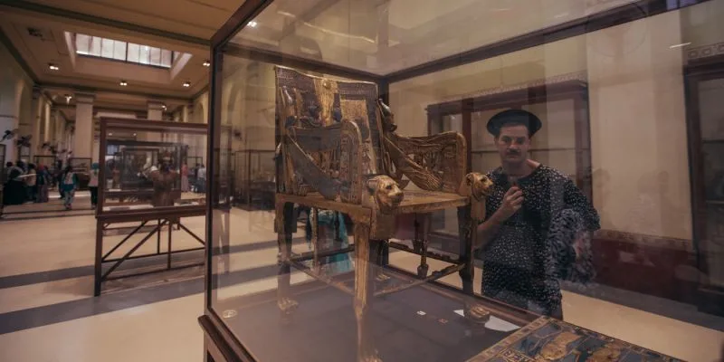 A Tourist beside the chair of Tutankhamun in the Egyptian Museum | Giza pyramids Tour | Cairo Day Tour | Egyptian Museum Tour A Tourist beside the chair of Tutankhamun in the Egyptian Museum | Giza pyramids Tour | Cairo Day Tour | Egyptian Museum Tour