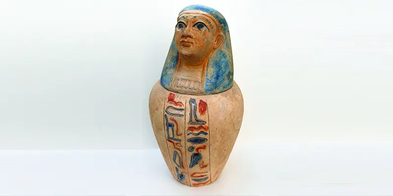Pottery replica of a canopic jar shaped like King Tutankhamun, inspired by ancient Egyptian funerary artifacts, purchased in Giza, Egypt.