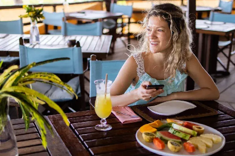 Happy woman while dining in Zanzibar
