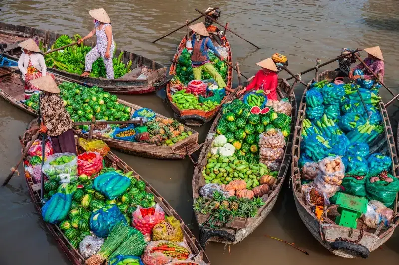Selling fruits on floating market, Mekong River Delta