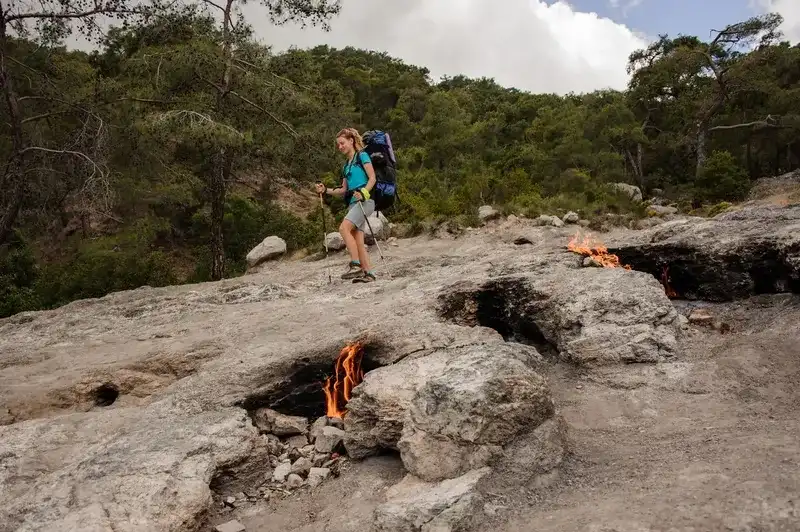 Woman walking on the rocks of the mysterious Chimaera mountain near the Cirali in Turkey