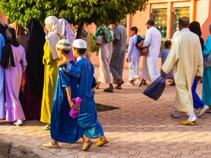 Two kids going to the prayer of Aid Al Adha in Marrakech, Morocco
