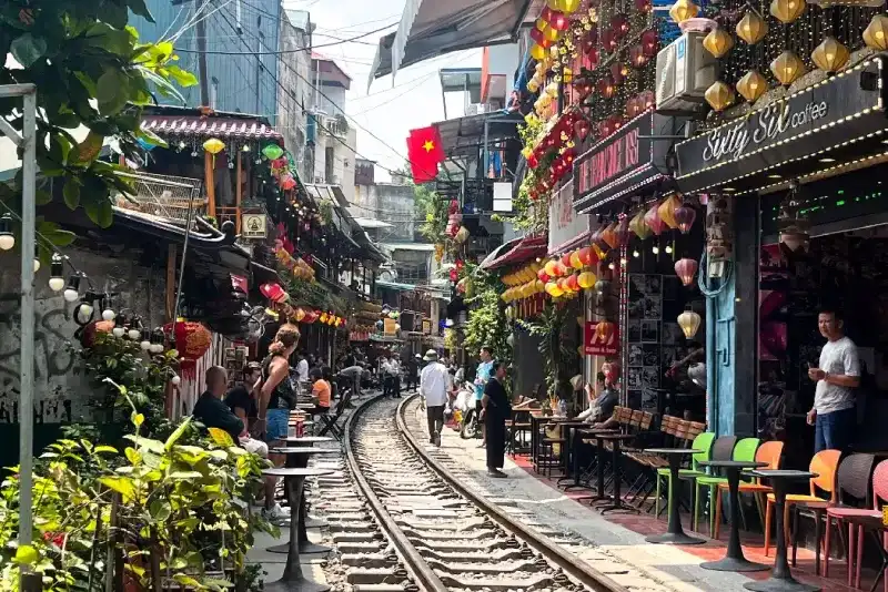 Calle del Tren de Hanói, los turistas se sientan en los cafés que bordean las vías.