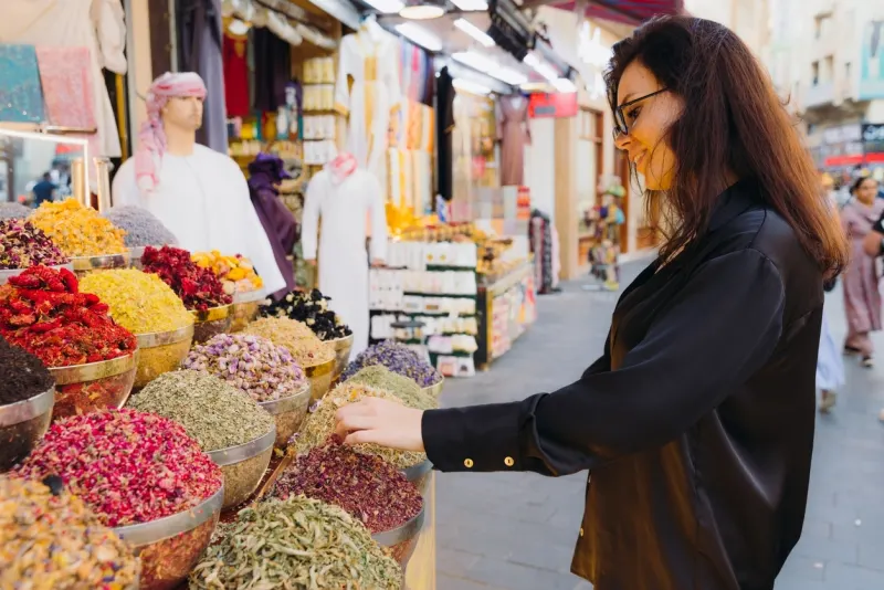 Woman Shopping at Spice and Dyes Market in Dubai City 
