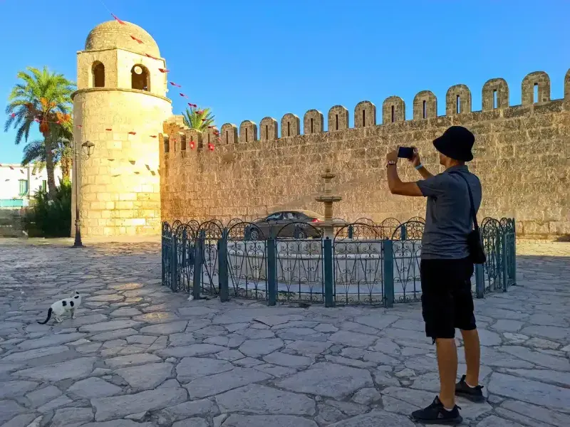 A tourist photographs the Great Mosque in Sousse, Tunisia