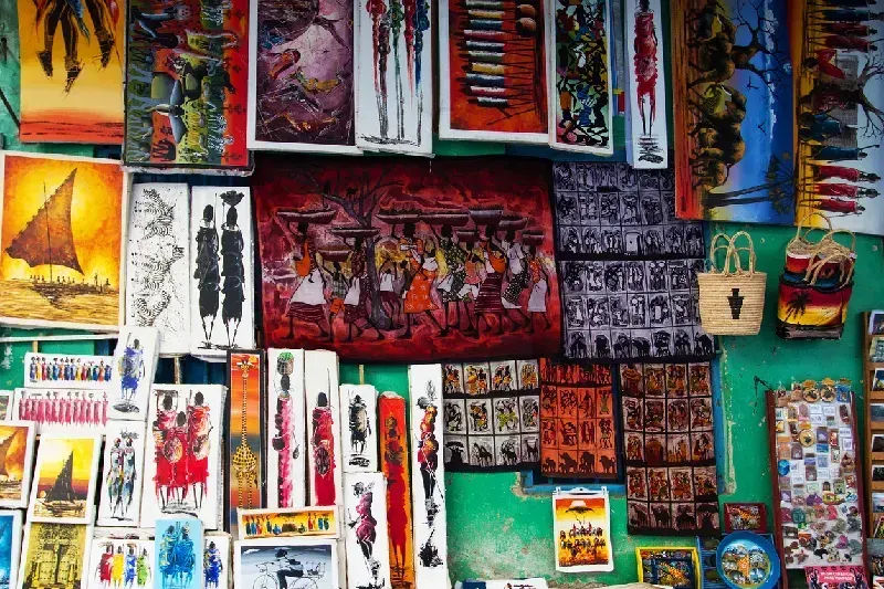 Local store selling colorful tingatinga paintings and other souvenirs in Stone Town