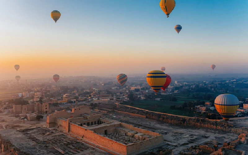 Golden Sunrise Balloons Over the Ancient Medinet Habu Ruins in Luxor