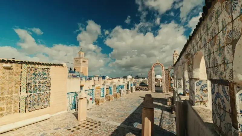 Exploring Historic Tunisian Rooftop With Ornate Tiles and Archways.
