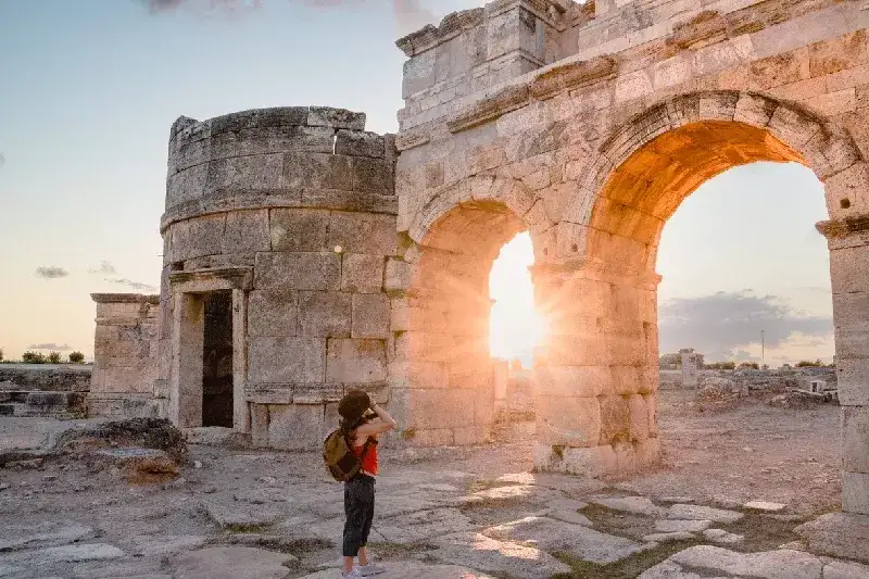 Tourist girl capturing Hierapolis ruins.