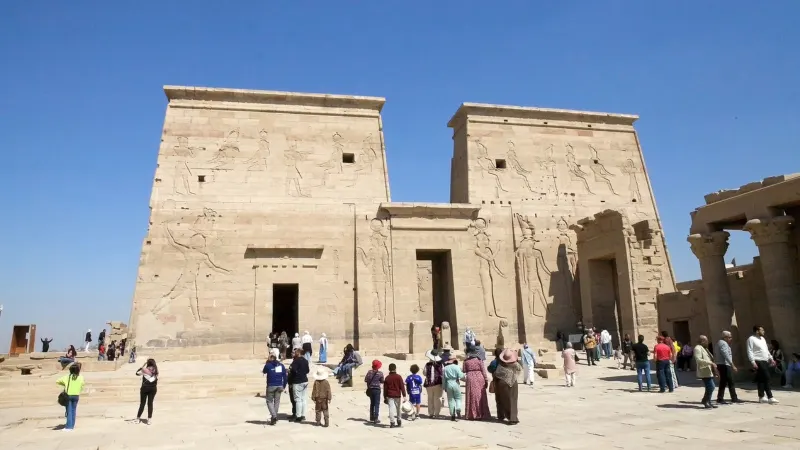 Tourists are visiting the Philae temple complex in Aswan