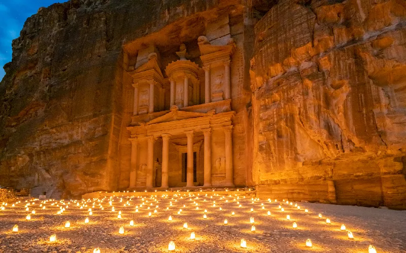 The so-called Treasury (Khazneh) in Petra, Jordan at night illuminated by candles.