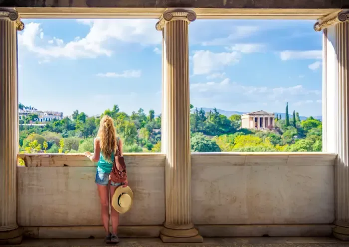 Woman tourist looking at Temple of Hephaestus, Athens in Greece- Ancient Agora 
