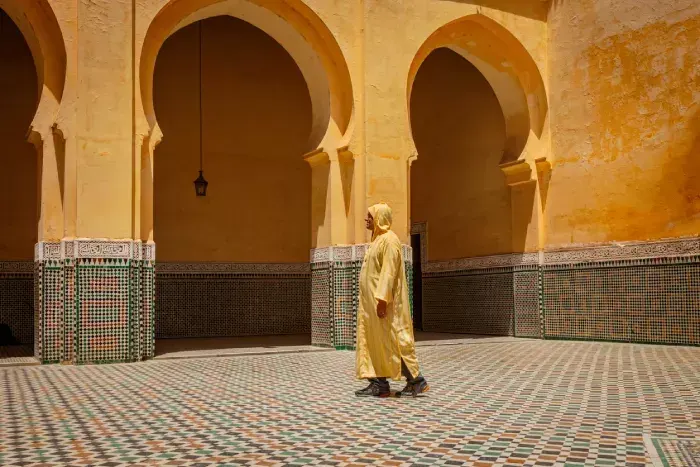 Man walking in the mausoleum of moulay ismail in meknes