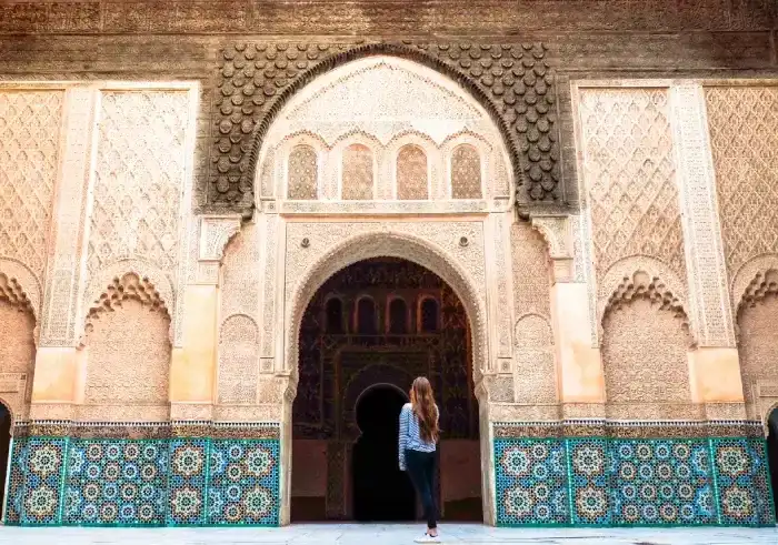 A woman standing in front of Beautiful architecture in marrakech