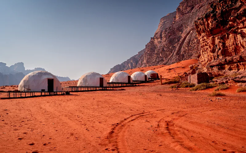 Campsites in Wadi Rum desert, Jordan, buildings amidst Martian landscape.