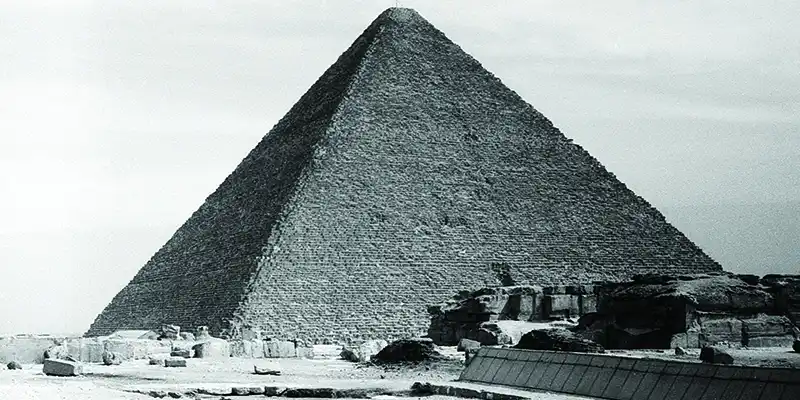 Giza pyramid complex in Egypt, showcasing the iconic pyramids standing tall on the desert plateau, representing the grandeur of ancient Egyptian civilization.