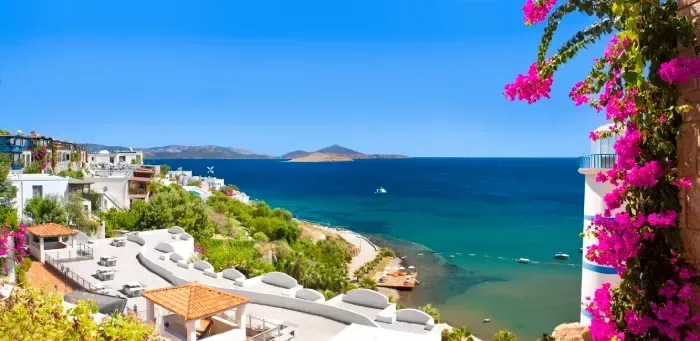 Beautiful flowers frame a sea view of Ortakent, Bodrum, Turkey 