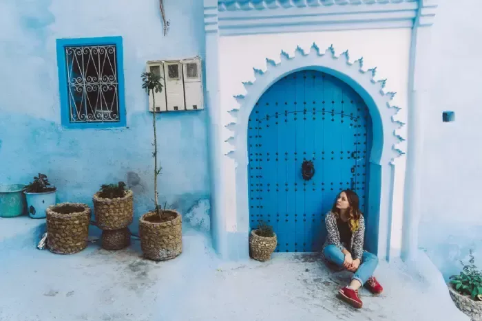 Woman sitting near the doors in Chefchaouen