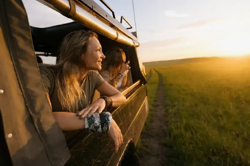 Woman enjoying a sunset wildlife safari ride in Kenya