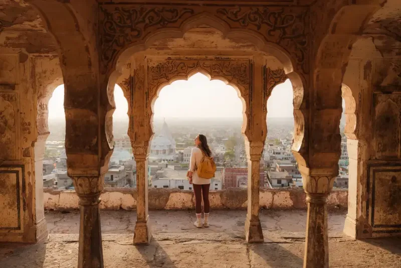 Woman looking at Jaipur cityscape at sunset