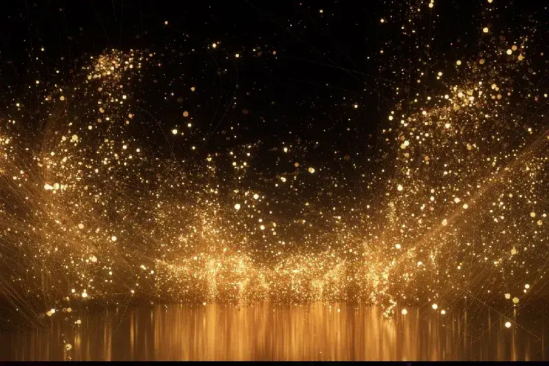 Durch die Luft fliegende, glitzernde goldene Partikel vor abstraktem Hintergrund.