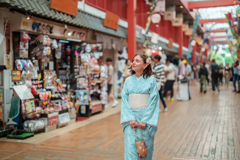 Una turista que viaja sola está disfrutando de la experiencia de vestir ropa tradicional japonesa, un kimono.