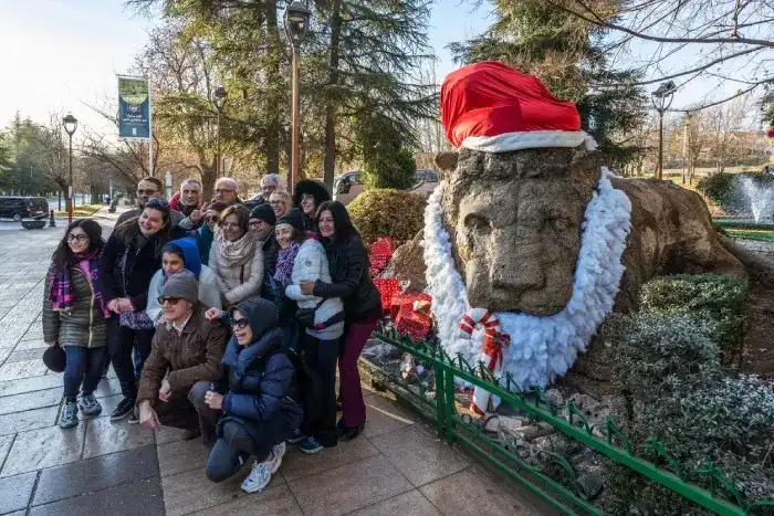 Tourists take photos at the lion statue in Ifrane 