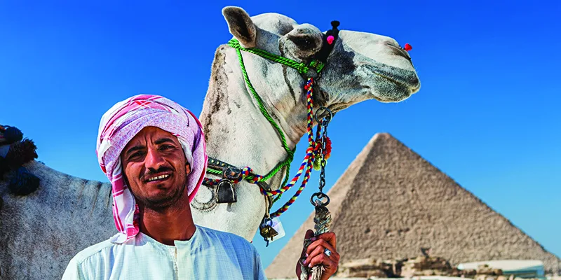  Bedouin man standing near the Pyramid of Menkaure at the Giza Plateau, Egypt