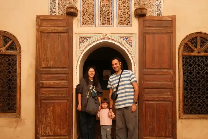 Family traveling in Morocco standing in traditional doorway