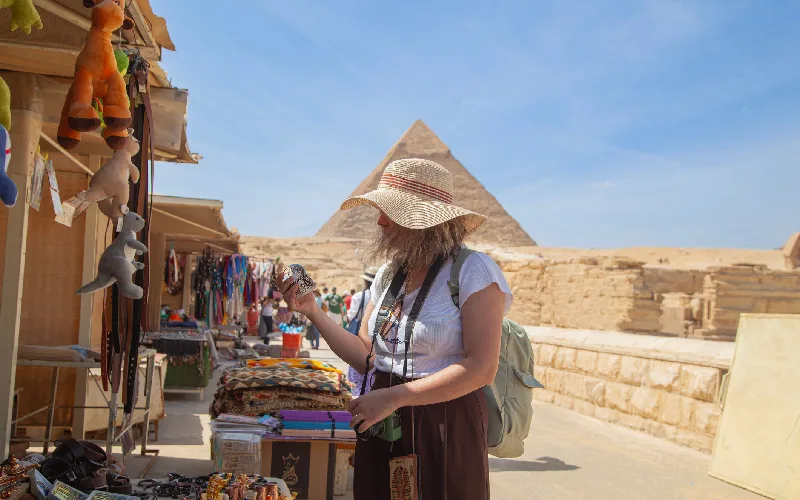Woman shopping from street vendors at the pyramids of Giza.