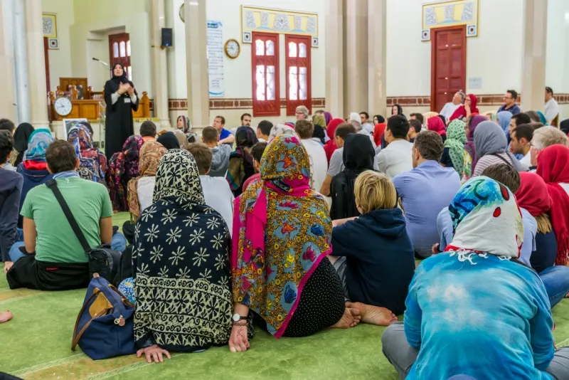 Non-Muslim guests listening a lecture from a Muslim female teacher inside of Jumeirah Mosque, the only mosque in Dubai which is open to the public and receiving non-Muslim guests