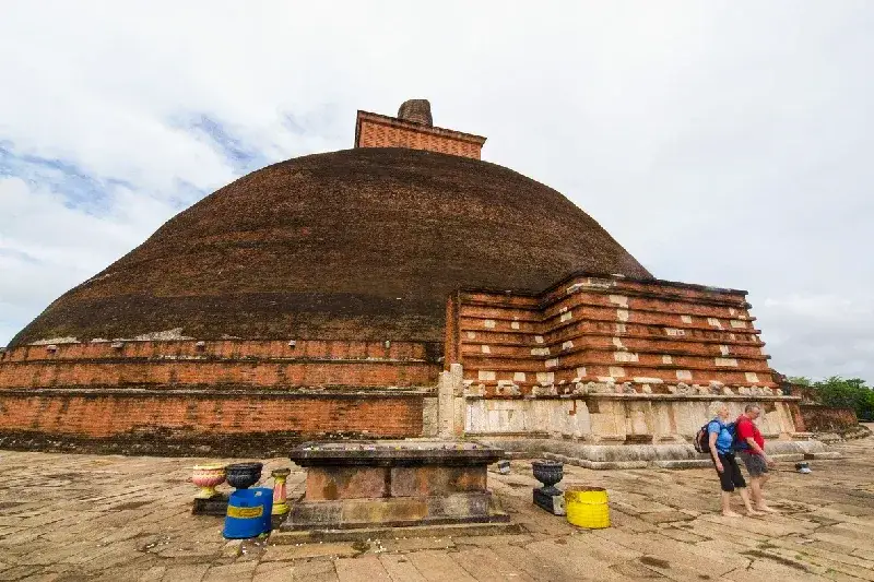 Tourists walking at the site of big ancient Stupa, Abhayagiri Dagaba 