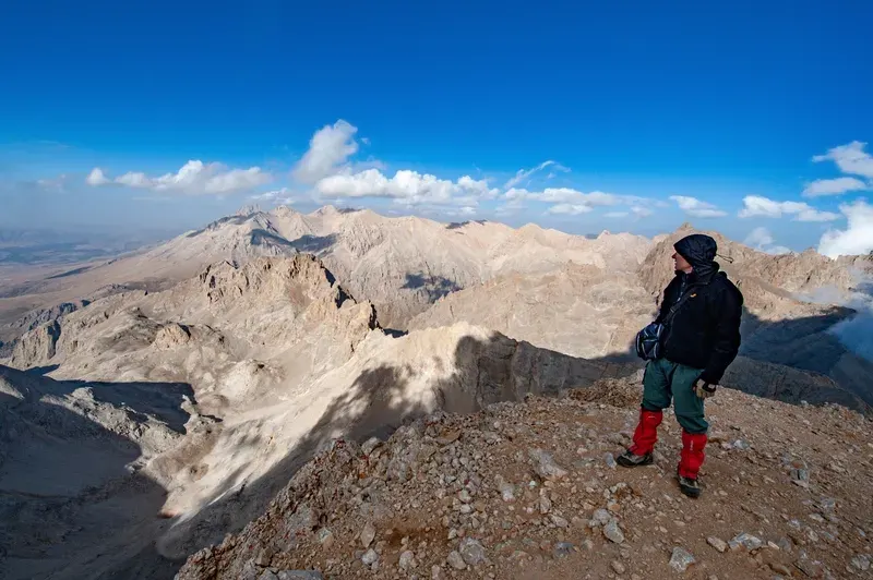 A mountaineer looking from the Alaca peak of the Aladağlar mountains towards Demirkazık Mountain.