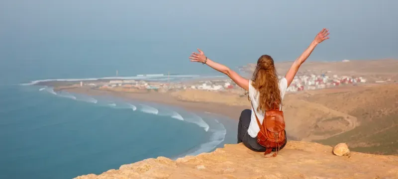 Woman tourist looking at panoramic Morocco coast- Imsouane