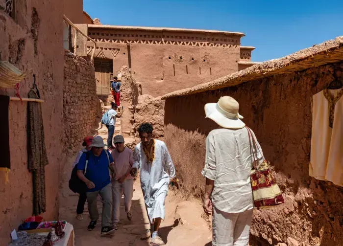 ourists and shops on the street at the ancient ksar of Ait Benhaddou 