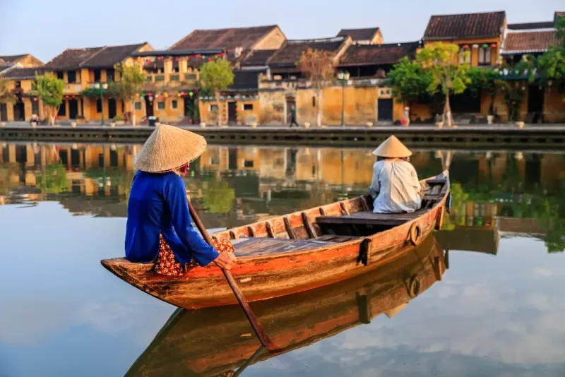 Mujeres vietnamitas remando en el casco antiguo de la ciudad de Hoi An, Vietnam. 