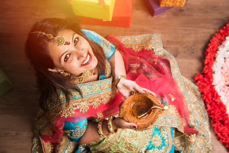 Indian girl holding diya on diwali festival night