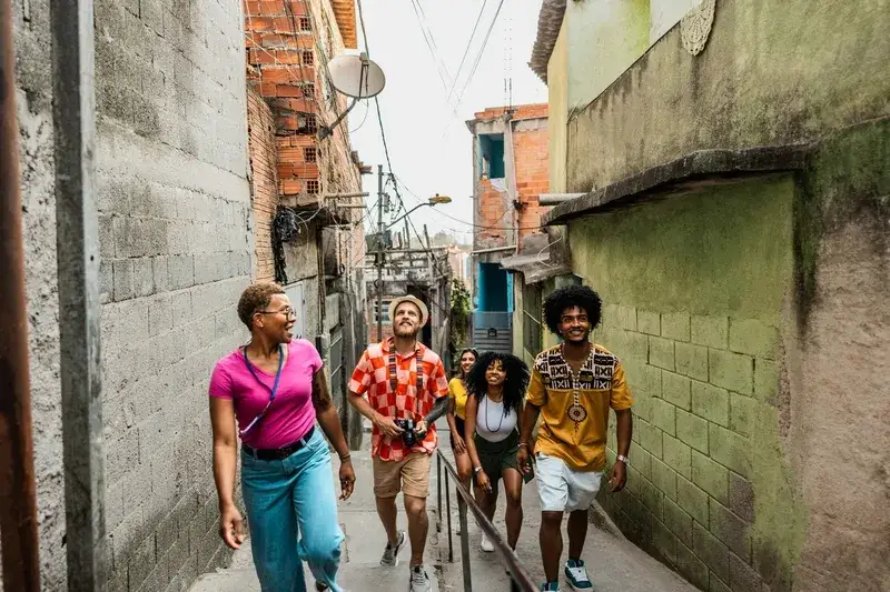 tourists walk in the Favela