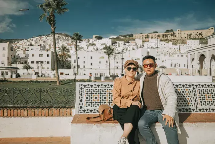 Asian Chinese Tourist couple looking at camera in front of old town Tetouan