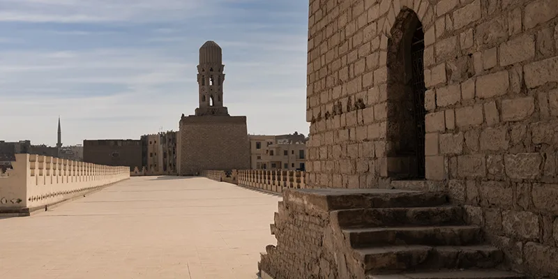 View of Al-Hakim Mosque rooftop and minaret in Cairo’s historic district, Egypt