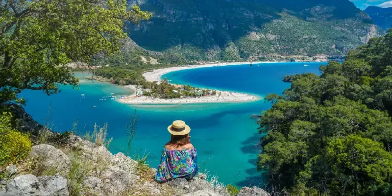 A woman admiring the stunning Oludeniz view in Fethiye, summer in Turkey.