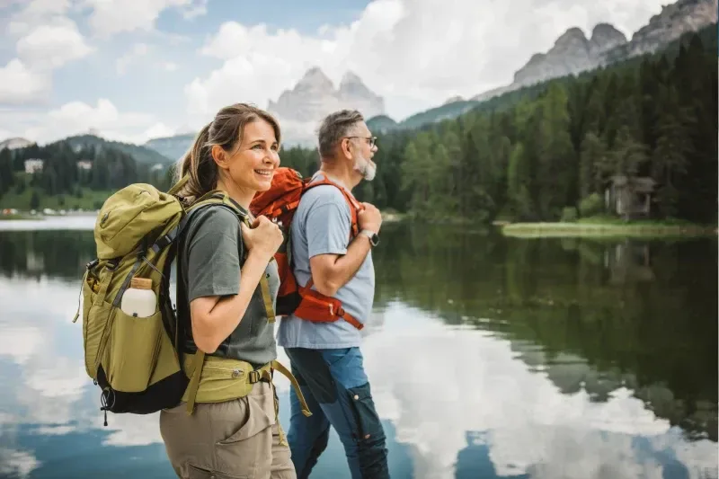 Reifes Paar betrachtet einen See in den Dolomiten, Italien.