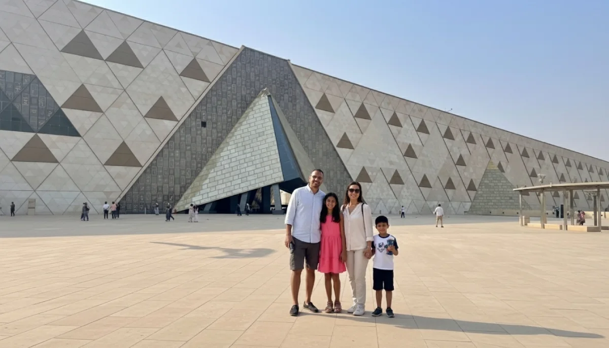 Family posing in front of the Grand Egyptian Museum entrance in Giza, Egypt, during a sightseeing tour.